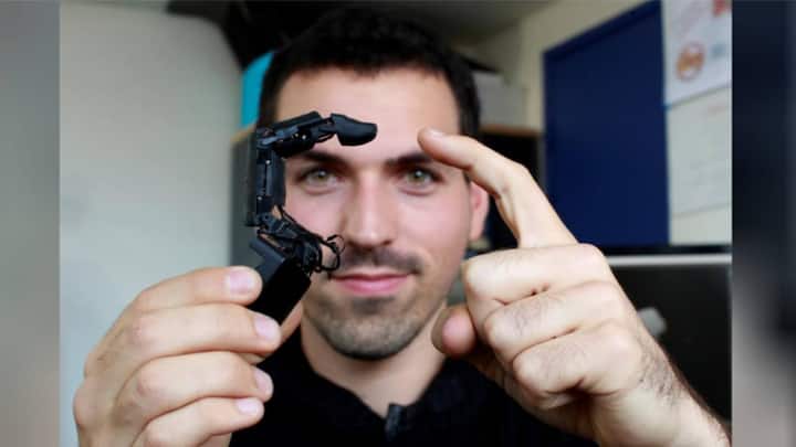 Robot finger that attaches to phones, wriggles across tables and stroke your hand