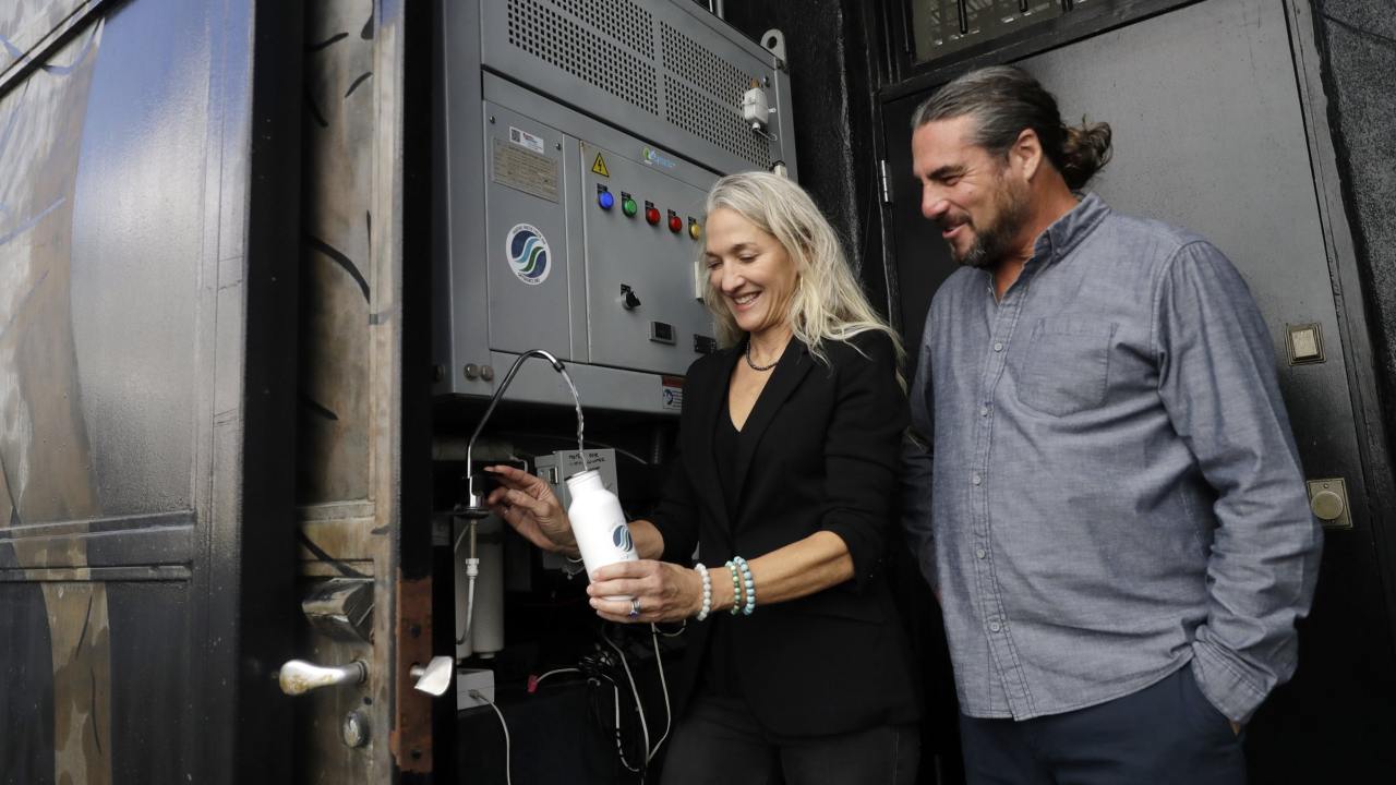 Skysource/Skywater Alliance co-founders David Hertz, right, and his wife Laura Doss-Hertz demonstrate how the device, Skywater 300, works. The company won the $1.5 million XPrize For Water Abundance for developing the machine, which makes water 
