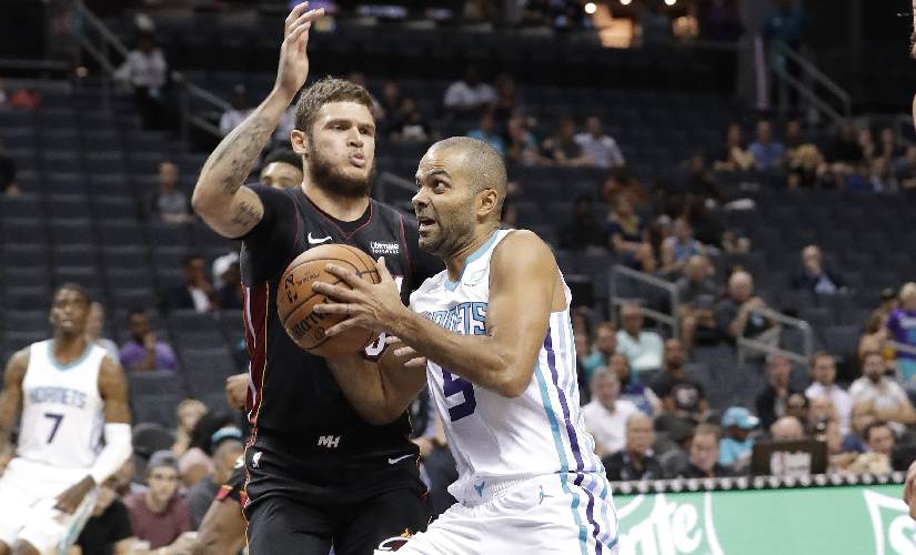 Charlotte Hornets' Tony Parker (right) drives against Miami Heat's Tyler Johnson during a preseason game. AP Photo