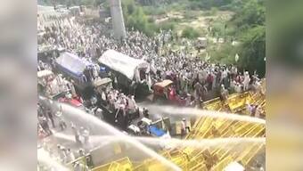 Police halt farmers' march at Delhi-UP border using water cannons, tear gas shells; protesters break barricades
