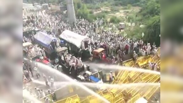 Police halt farmers' march at Delhi-UP border using water cannons, tear gas shells; protesters break barricades