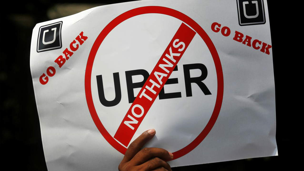 A man holds a placard during a protest against Ola and Uber outside Uber's head office in Mumbai, India, October 22, 2018. REUTERS/Francis Mascarenhas