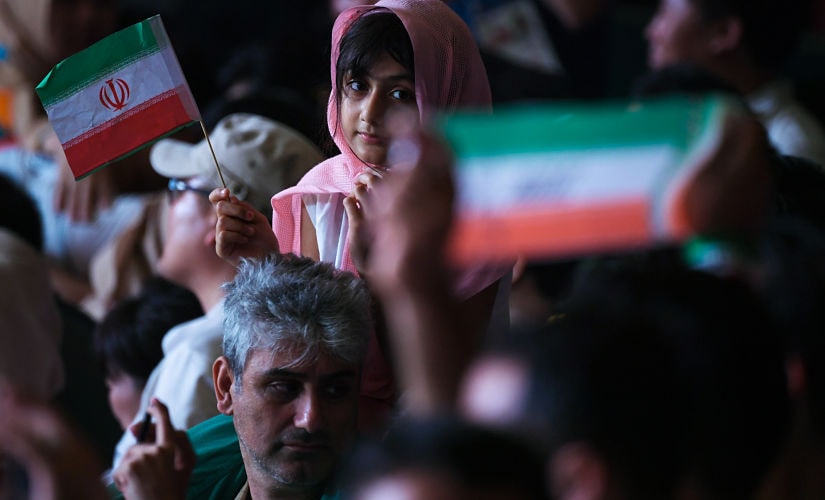 Young Iranian fan watches the 2018 Asian Games men's kabaddi final between Iran and South Korea. AFP