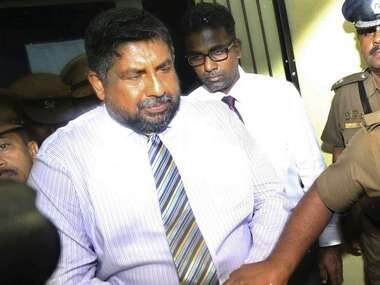 Chief of Defense Staff Admiral Ravindra Wijegunaratne is taken away by police officers from a court in Colombo, Sri Lanka, Wednesday. AP