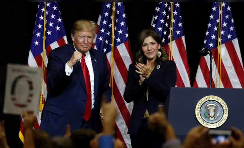 US President Donald Trump brings gubernatorial candidate Kristi Noem on stage during a Republican Party fundraiser in South Dakota. Reuters
