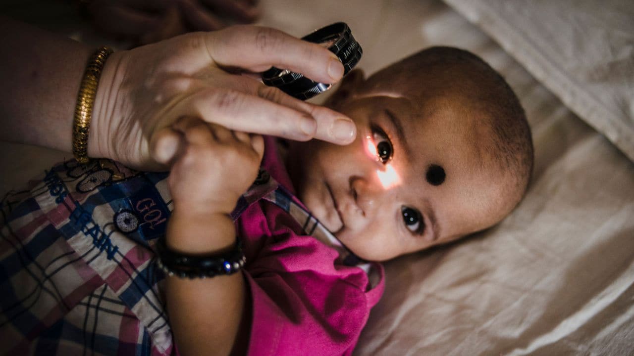 A doctor examines the eyes of a prematurely born child successfully treated for retinopathy in a Hyderabad Eye hospital. Image credit: Time to See
