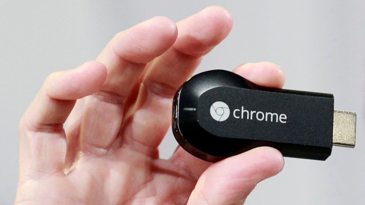 Mario Queiroz, vice president of product management, holds the new Google Chromecast dongle as it is announced during a Google event at Dogpatch Studio in San Francisco, California, July 24, 2013.  Google Inc on Wednesday unveiled the $35 Chromecast device for watching online videos on television. REUTERS/Beck Diefenbach (UNITED STATES - Tags: BUSINESS SCIENCE TECHNOLOGY TELECOMS) - GM1E97P03IP01