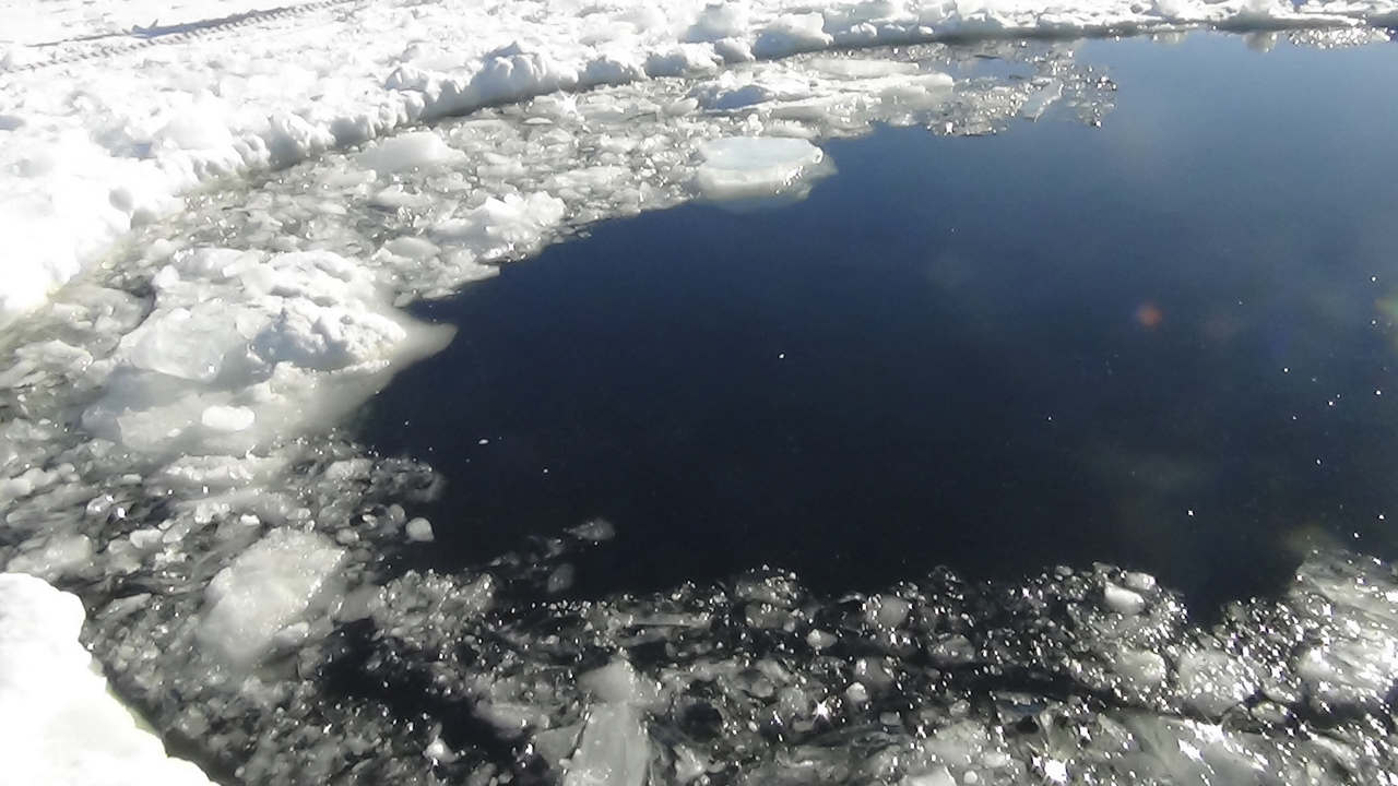 A Russian policeman works near an ice hole, said by the Interior Ministry department for Chelyabinsk region to be the point of impact of a meteorite seen earlier in the Urals region, at lake Chebarkul some 80 kilometers (50 miles) west of Chelyabinsk February 15, 2013. The meteorite streaked across the sky and exploded over central Russia on Friday, sending fireballs crashing to earth which shattered windows and damaged buildings, injuring more than 500 people. REUTERS/Chelyabinsk region Interior Ministry/Handout (RUSSIA - Tags: DISASTER SCIENCE TECHNOLOGY ENVIRONMENT TPX IMAGES OF THE DAY) ATTENTION EDITORS - THIS IMAGE WAS PROVIDED BY A THIRD PARTY. FOR EDITORIAL USE ONLY. NOT FOR SALE FOR MARKETING OR ADVERTISING CAMPAIGNS. THIS PICTURE IS DISTRIBUTED EXACTLY AS RECEIVED BY REUTERS, AS A SERVICE TO CLIENTS. BEST QUALITY AVAILABLE - GM1E92G00NL01