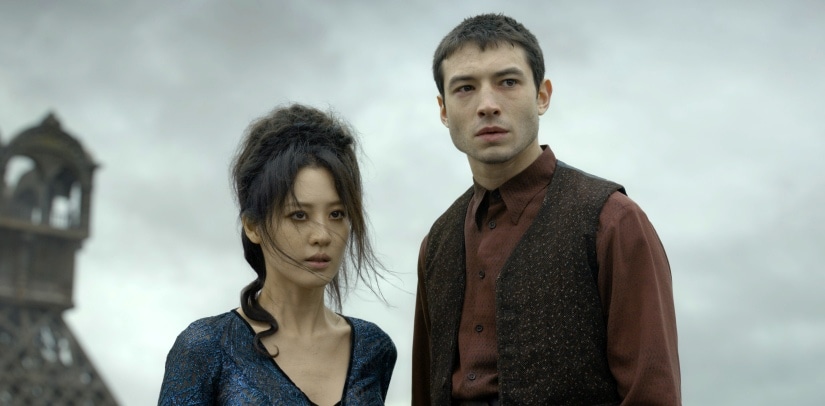 This image released by Warner Bros. Pictures shows Claudia Kim, left and Ezra Millerin a scene from "Fantastic Beasts: The Crimes of Grindelwald." (Jaap Buitendijk/Warner Bros. Pictures via AP)