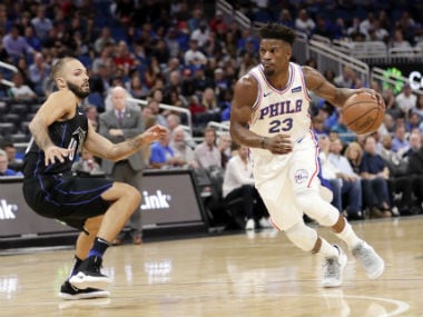 Philadelphia 76ers' Jimmy Butler (23) drives past Orlando Magic's Evan Fournier during the first half. AP