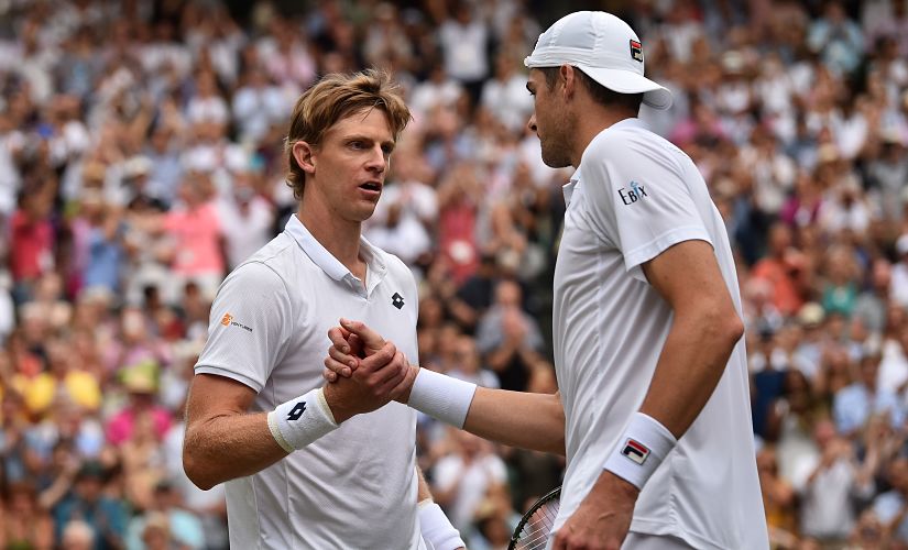 South Africa's Kevin Anderson (L) shakes hands after winning against US player John Isner during the final set tie-break of their men's singles semi-final match on the eleventh day of the 2018 Wimbledon Championships at The All England Lawn Tennis Club in Wimbledon, southwest London, on July 13, 2018. Anderson won the match 7-6, 6-7, 6-7, 6-4, 26-24. / AFP PHOTO / POOL / Glyn KIRK / RESTRICTED TO EDITORIAL USE