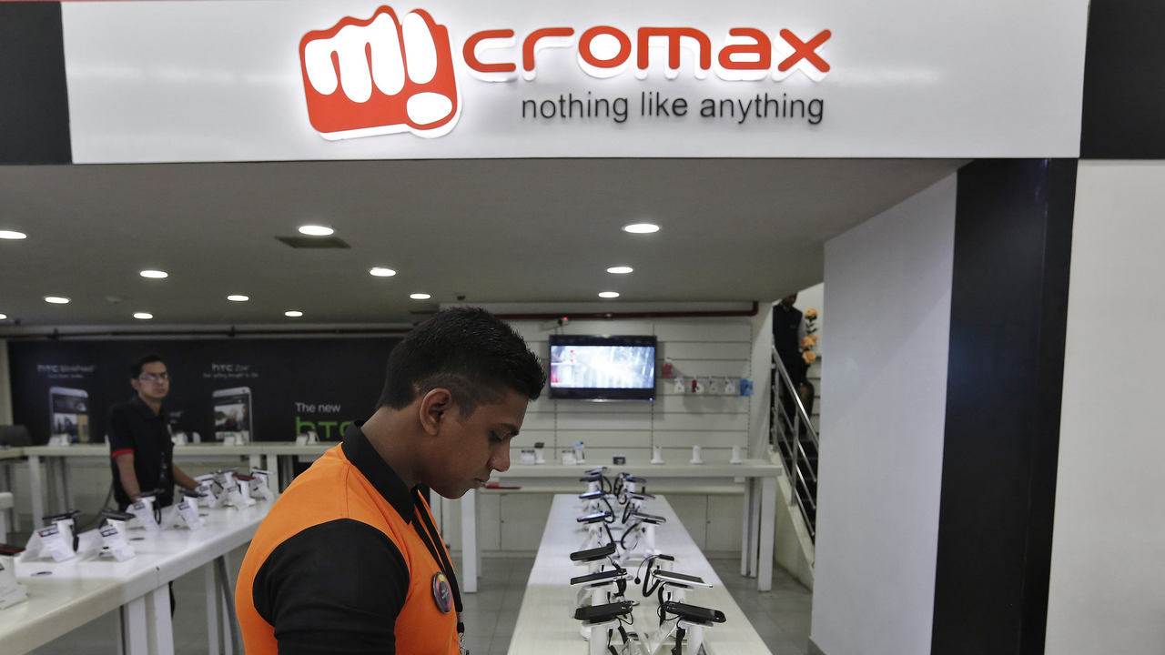 An employee stands at the counter of Micromax mobile phones at a showroom in New Delhi. Reuters