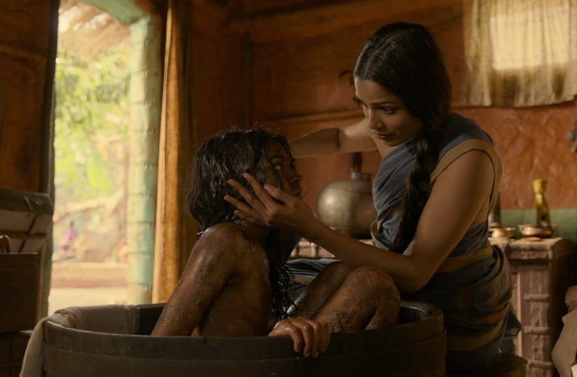 Rohan Chand as "Mowgli" and Freida Pinto as "Messua" in the Netflix film "Mowgli: Legend of the Jungle"