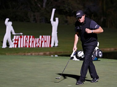 Phil Mickelson celebrates after sinking a put to defeat Tiger Woods at a playoff hole. AP Photo