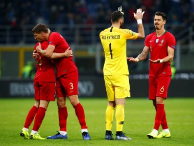 Portugal's Rui Patricio and Jose Fonte celebrate after the match. Reuters