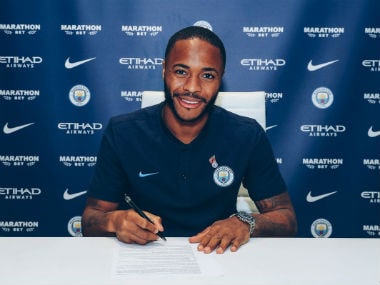 Raheem Sterling poses after signing contract extension. AFP