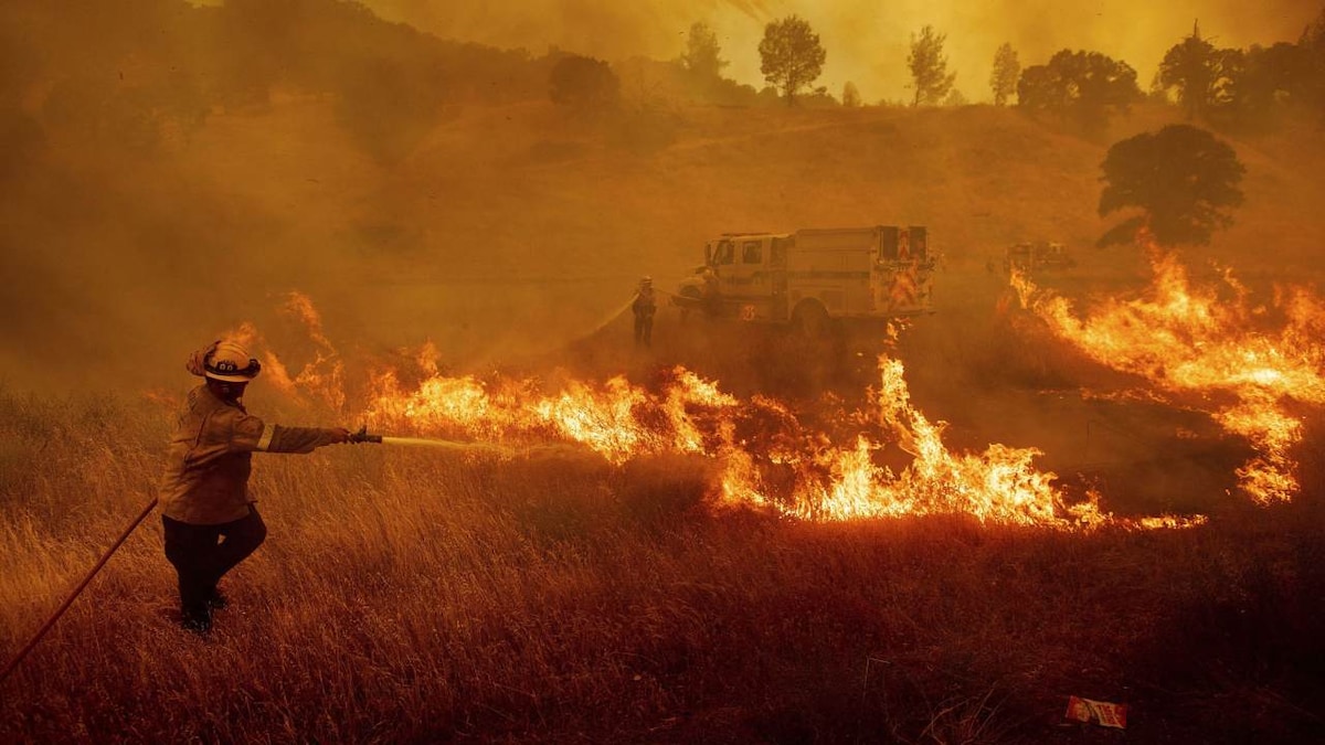 California fires blaze across million acres of forest amid fears of further spread