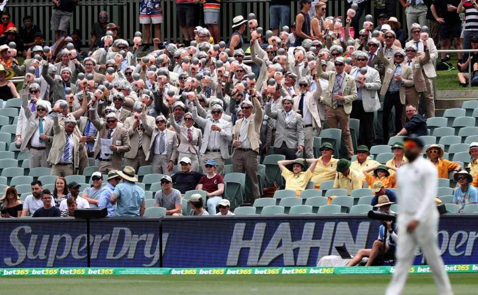 Spectators dressed as late Australian cricketer and television commentator Richie Benaud cheer during play on day two. AP