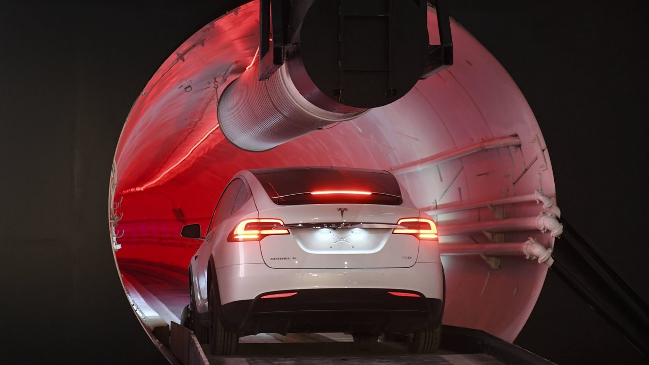 A modified Tesla Model X drives in the tunnel entrance before an unveiling event. Image: AP