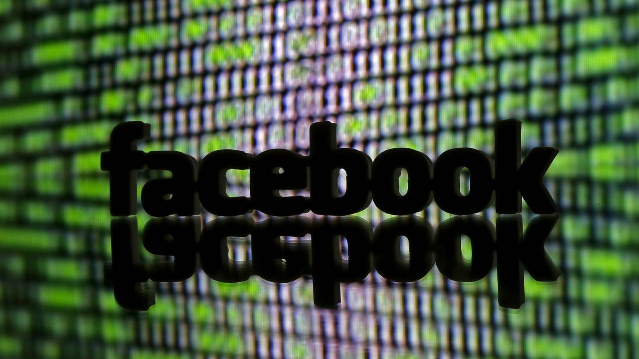FILE PHOTO: A 3D printed Facebook logo is seen in front of displayed cyber code in this illustration taken March 22, 2016. REUTERS/Dado Ruvic/Illustration/File Photo