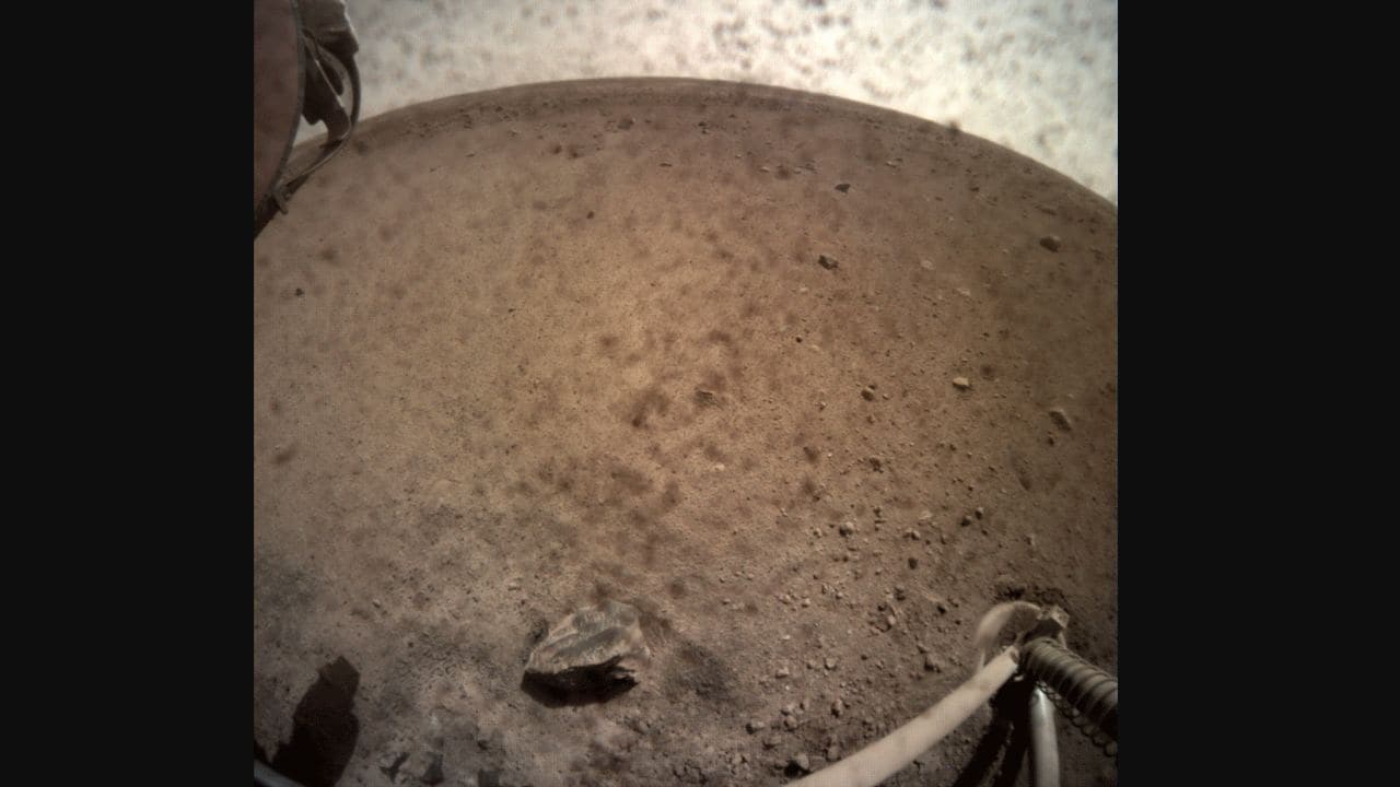 InSight flipped open the lens cover on its Instrument Context Camera (ICC) on 30 Nov to captured this view of Mars. Located below the deck of the Mars lander, the ICC has a fisheye lens, creating a curved horizon. Image courtesy: NASA
