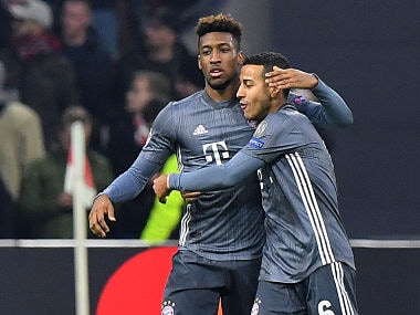 Bayern Munich's French forward Kingsley Coman (L) is congratulated by Bayern Munich's Spanish midfielder Thiago Alcantara after scoring their third goal during the UEFA Champions League Group E football match between AFC Ajax and FC Bayern Munchen at the Johan Cruyff Arena in Amsterdam on December 12, 2018. (Photo by EMMANUEL DUNAND / AFP)