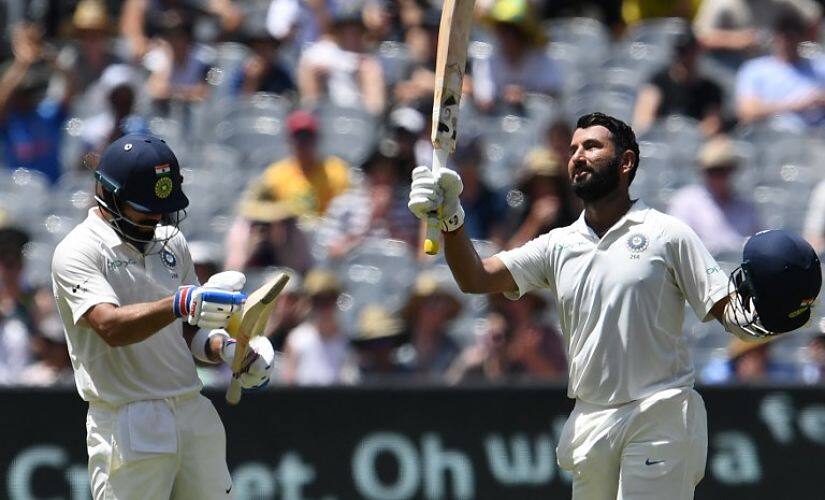 India’s batsman Cheteshwar Pujara (R) celebrates reaching his century (100 runs) with team’s captain Virat Kohli during day two of the third cricket Test match between Australia and India in Melbourne on December 27, 2018. (Photo by WILLIAM WEST / AFP) / – IMAGE RESTRICTED TO EDITORIAL USE - STRICTLY NO COMMERCIAL USE –
