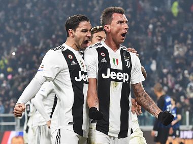 Juventus' Mario Mandzukic, right, celebrates with teammate Mattia De Sciglio, left, and Paulo Dybala after scoring his side's opening goal during the Serie A soccer match between Juventus and Inter Milan at the Turin Allianz stadium, Italy, Friday, Dec. 7, 2018. (Andrea Di Marco/ANSA via AP)