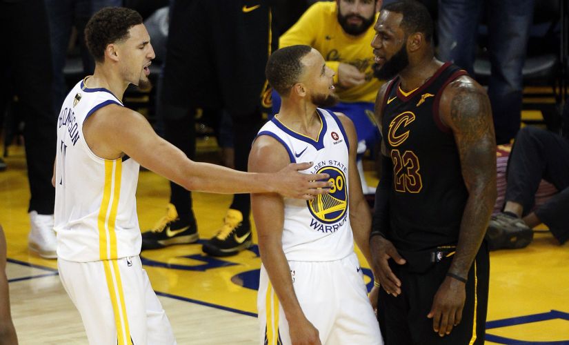 Cleveland Cavaliers' LeBron James argues with Golden State Warriors' Stephen Curry (centre) as Klay Thompson (left) moves in during Game 1 of the 2018 NBA Finals. USA TODAY Sports/Reuters