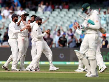 India’s Virat Kohli celebrates with a teammate after the dismissal of Peter Handscomb in first Test at Adelaide. AP