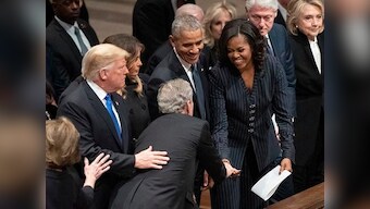 George W Bush shares candy with Michelle Obama at former president's funeral; ex-FLOTUS says they are 'partners in crime'