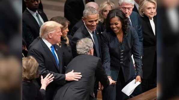George W Bush shares candy with Michelle Obama at former president's funeral; ex-FLOTUS says they are 'partners in crime'