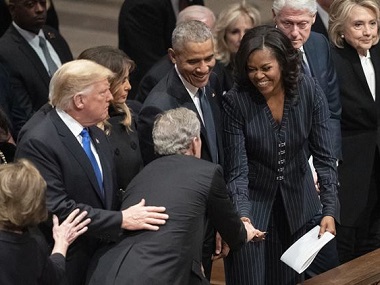 George W Bush shares candy with Michelle Obama at former president's funeral; ex-FLOTUS says they are 'partners in crime' George W Bush shares candy with Michelle Obama at former president's funeral; ex-FLOTUS says they are 'partners in crime'
