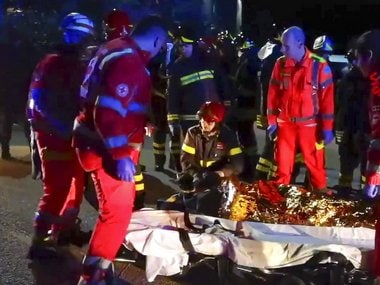 In this frame taken from video rescuers assist injured people outside a nightclub in Corinaldo, central Italy, early Saturday. AP