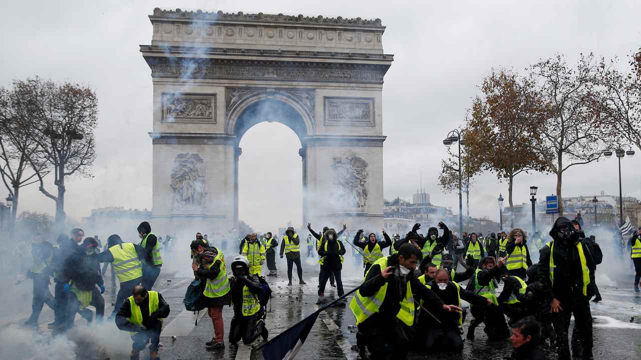 Paris riots 'Yellow vests' activists torch cars, tag