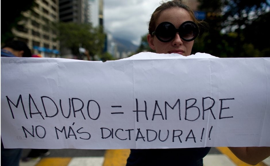Protesters said they were heeding the Opposition's call for another mass demonstration despite the heavy-handed response by security forces over the last week to quell anti-government protests. A woman held a placard with a message in Spanish reading: Protesters said they were heeding the Opposition's call for another mass demonstration despite the heavy-handed response by security forces over the last week to quell anti-government protests. A woman held a placard with a message in Spanish reading: