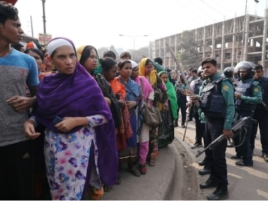 Police officers tell the garment workers who protest for higher wages to go to their workplace in Dhaka, Bangladesh. Reuters