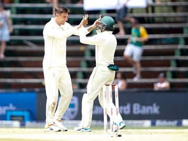 South African bowler Duanne Olivier (L) celebrates with teammate during the second day of the third Cricket Test match between South Africa and Pakistan at Wanderers cricket stadium on January 12, 2019 in Johannesburg, South Africa. (Photo by GIANLUIGI GUERCIA / AFP)