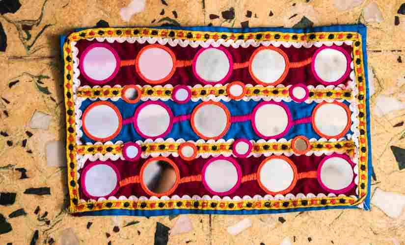 At least one kilogram mirrors cut in several shapes are used in a single Ghagra Choli estimate the community women.