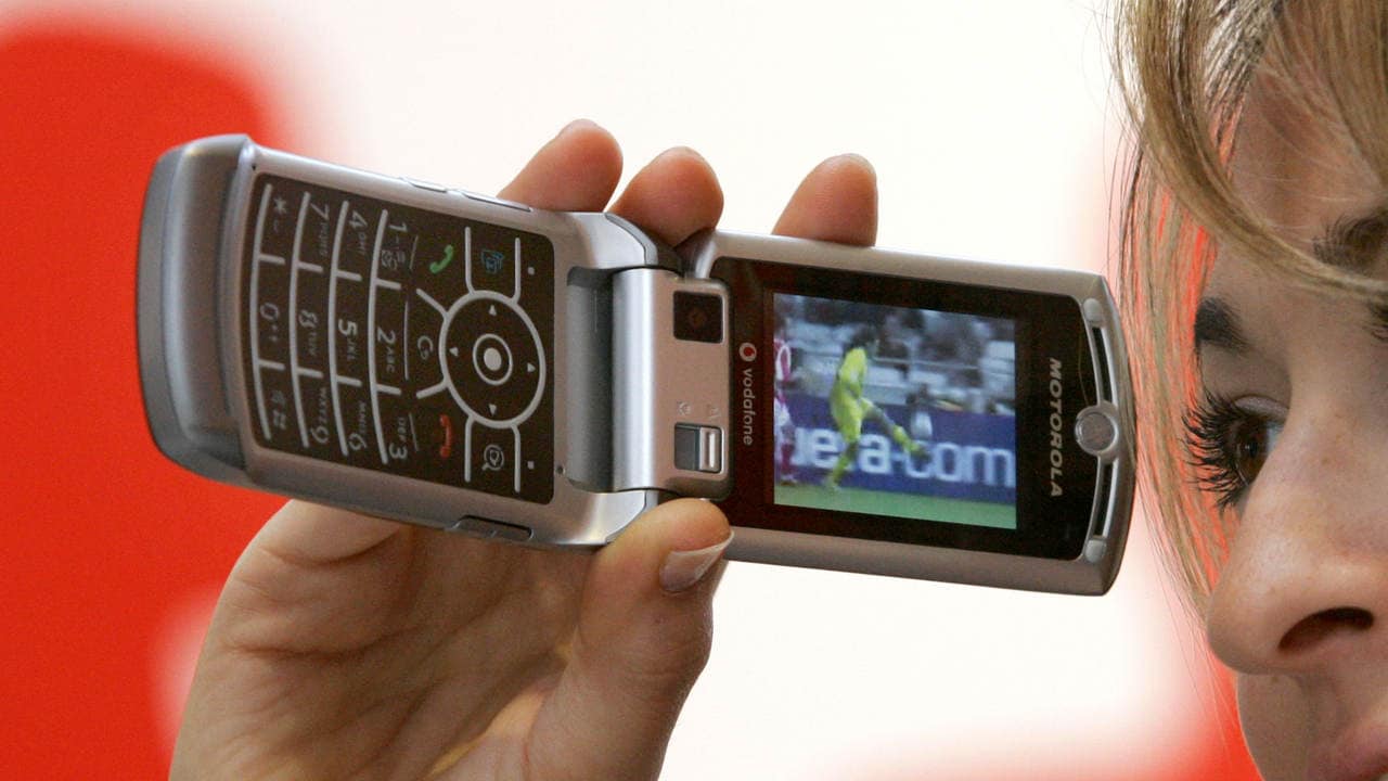 A model presents a TV service on a Motorola RAZR V3x phone. Image: Reuters