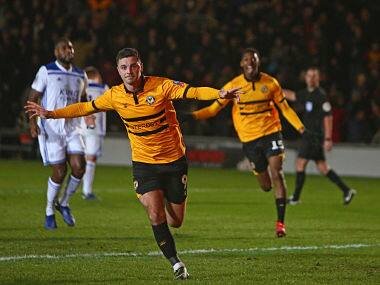 Newport County’s Padraig Amond (centre) celebrates after scoring their second goal against Leicester Cit. AFP