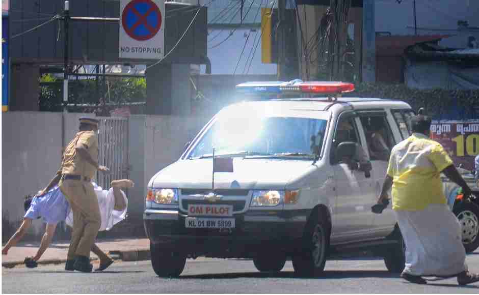 A youth Congress activist, who had come to wave black flag at Chief Minister Pinarayi Vijayan over the Sabarimala issue, falls after a minor knock by the chief minister convoy's pilot vehicle, in Thiruvananthapuram on Thursday. PTI A youth Congress activist, who had come to wave black flag at Chief Minister Pinarayi Vijayan over the Sabarimala issue, falls after a minor knock by the chief minister convoy's pilot vehicle, in Thiruvananthapuram on Thursday. PTI