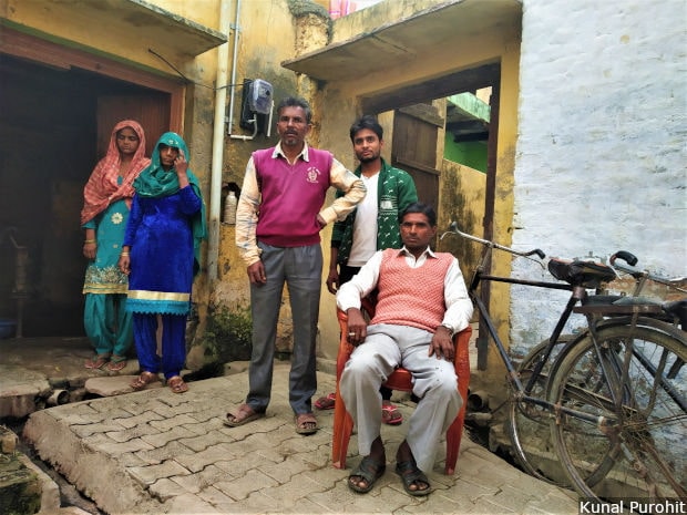 Pappu Khan, 45, sits outside the abandoned house of his older brother Ghulam Mohammed, who was lynched in a mango orchard just outside Soi village of Bulandshahr, allegedly by Hindu Yuva Vahini activists. His family and neighbours, seen standing around him, said they felt scared to live there and wanted to migrate. Image/Kunal Purohit