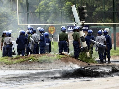 Riot police on the streets during protests over the hike in fuel prices in Harare. AP