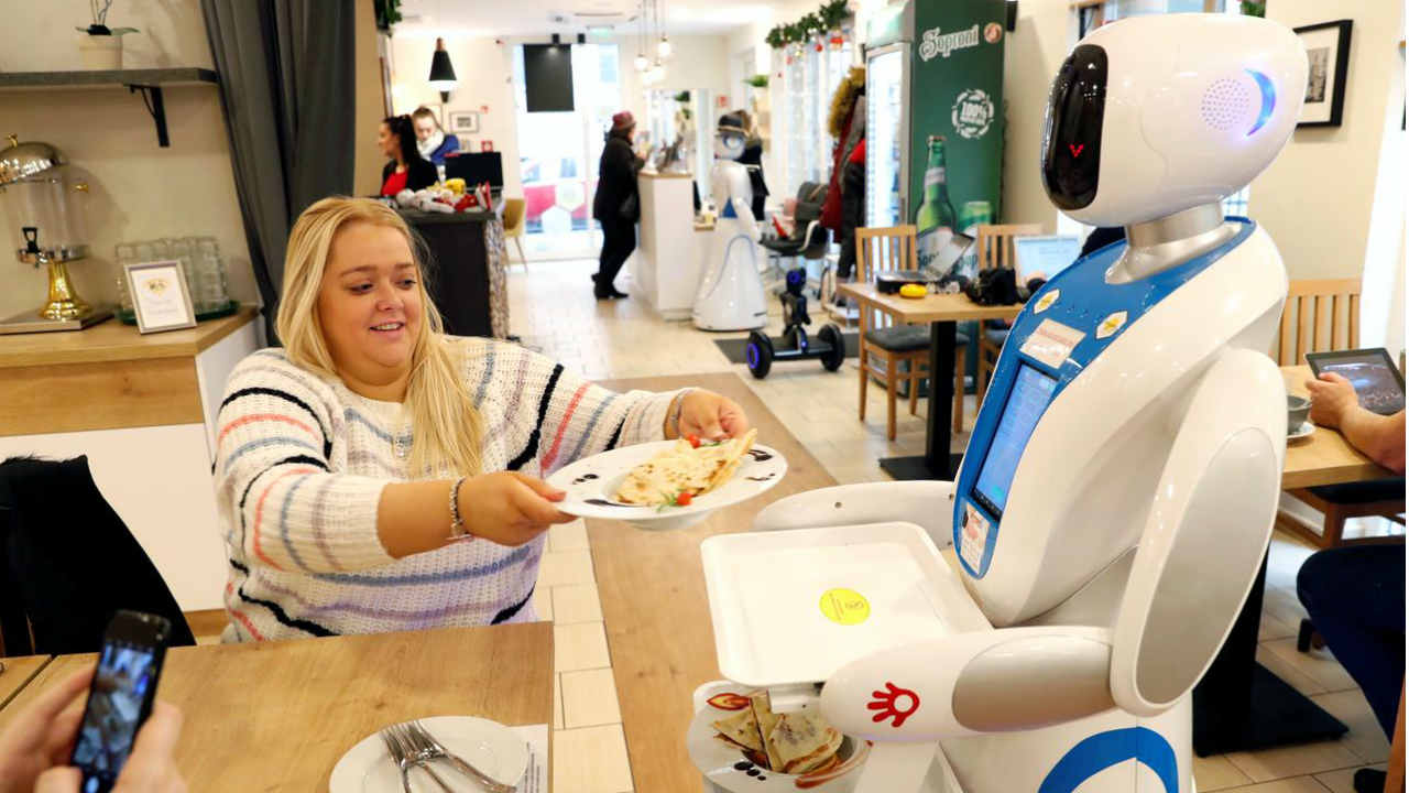 A robot waiter serves customers at a cafe in Budapest, Hungary, January 24, 2019. Picture taken January 24, 2019. REUTERS/Bernadett Szabo