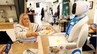 Robots at a Budapest cafe serve up food and drink, tell jokes, dance with kids