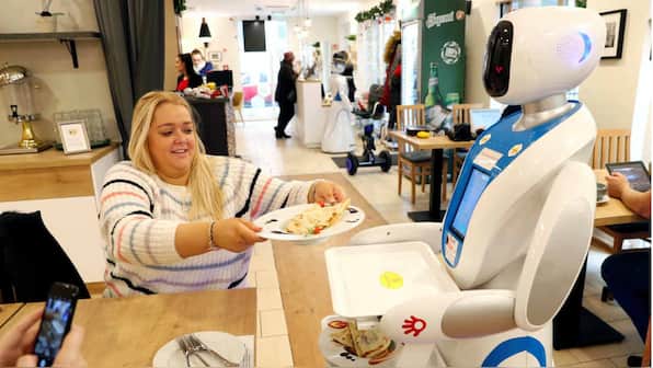 Robots at a Budapest cafe serve up food and drink, tell jokes, dance with kids