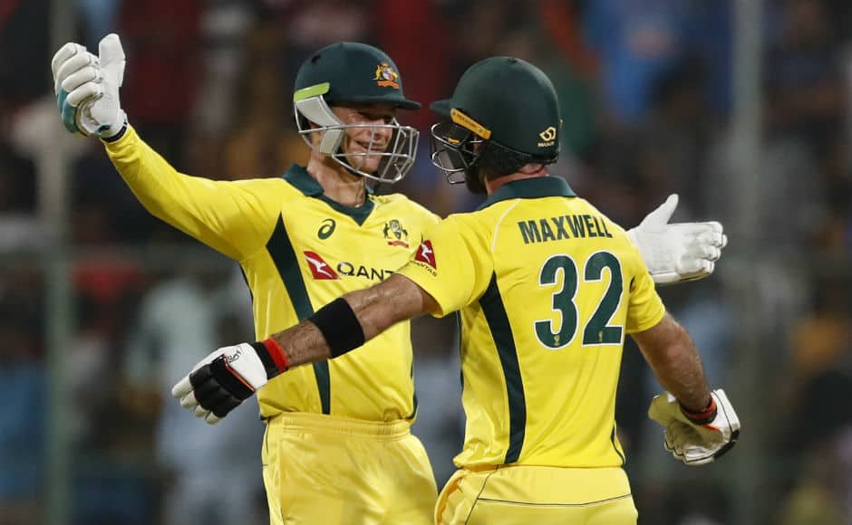 Peter Handscomb and Glenn Maxwell celebrate after guiding Australia to a seven-wicket victory at Bengaluru. AP