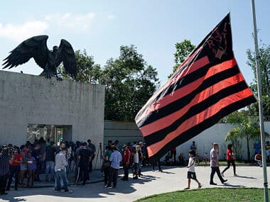 Friends of youth players, Flamengo fans and journalists stand at the entrance of the club&rsquo;s training center on Friday. AP Photo