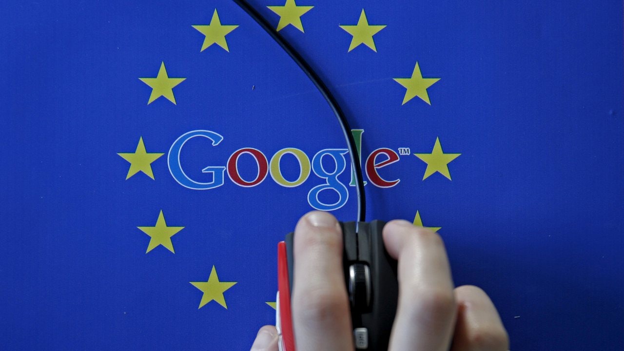 A woman hovers a mouse over the Google and European Union logos. Image: Reuters